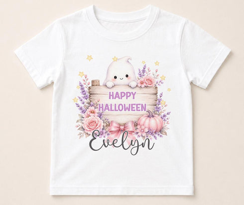 Personalised Halloween t-shirt featuring cute ghost holding wooden sign, pink pumpkins, flowers and custom name on white children's Halloween shirt