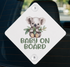 A diamond-shaped sign with a koala bear holding a leaf and the text "BABY ON BOARD" printed on it.