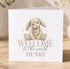 A white greeting card with a picture of a stuffed bunny rabbit and the text "Welcome to the world Henry" printed on it.