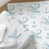 a repeating pattern of cartoon-style illustrations of a whale and an anchor, along with the text "Oscar" and "2" printed on the wrapping paper.