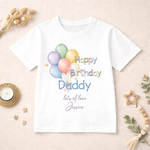 Personalised Happy Birthday Daddy children's white t-shirt with colourful balloon design and custom message displayed on a neutral styled background