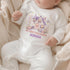 Personalised baby’s first Halloween white vest with a pastel pink and purple haunted house, cute ghosts, pumpkins and baby’s name.