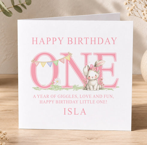 A personalized birthday card for a one-year-old named Isla, featuring a cute bunny and colorful flags.