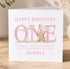 A personalized birthday card for a one-year-old girl named Sophia. The card features a teddy bear holding a pink banner and the text "Happy Birthday One" along with a message about the first birthday celebration.