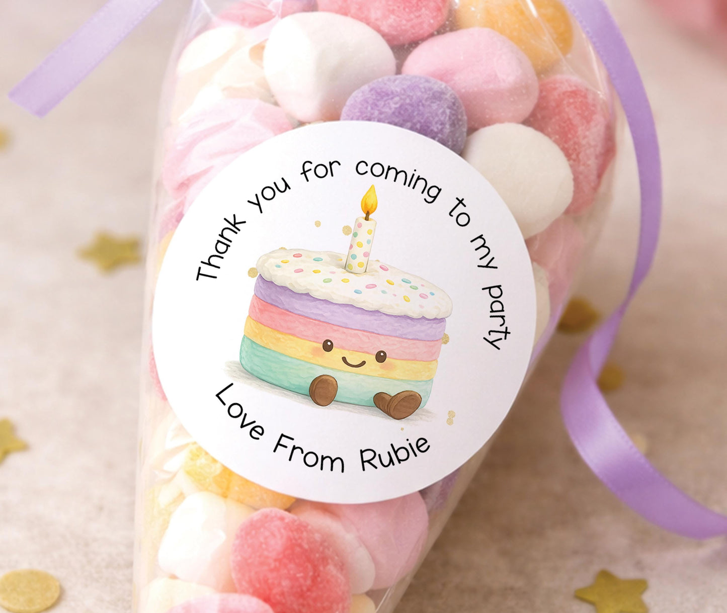 Sheet of personalised glossy round birthday cake stickers shown printed with a sample name