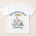A white t-shirt with a printed design featuring a castle and a young child wearing a crown. The text on the t-shirt says "When I wake up I will be three. Harley".