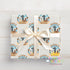 A gift box with a white ribbon tied around it, featuring a repeating pattern of a cowboy hat and a bull. The text "JAXON'S RODEO" is visible on the gift box.