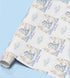 The image is a roll of wrapping paper with a repeating pattern of a blue dragon and clouds, along with the text "Welcome to the World" written on it.