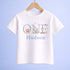 A white t-shirt with the word "Hudson" printed on it, along with illustrations of a lion, elephant, and giraffe.