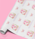a roll of paper with a repeating pattern of pink butterflies and the number 3.
