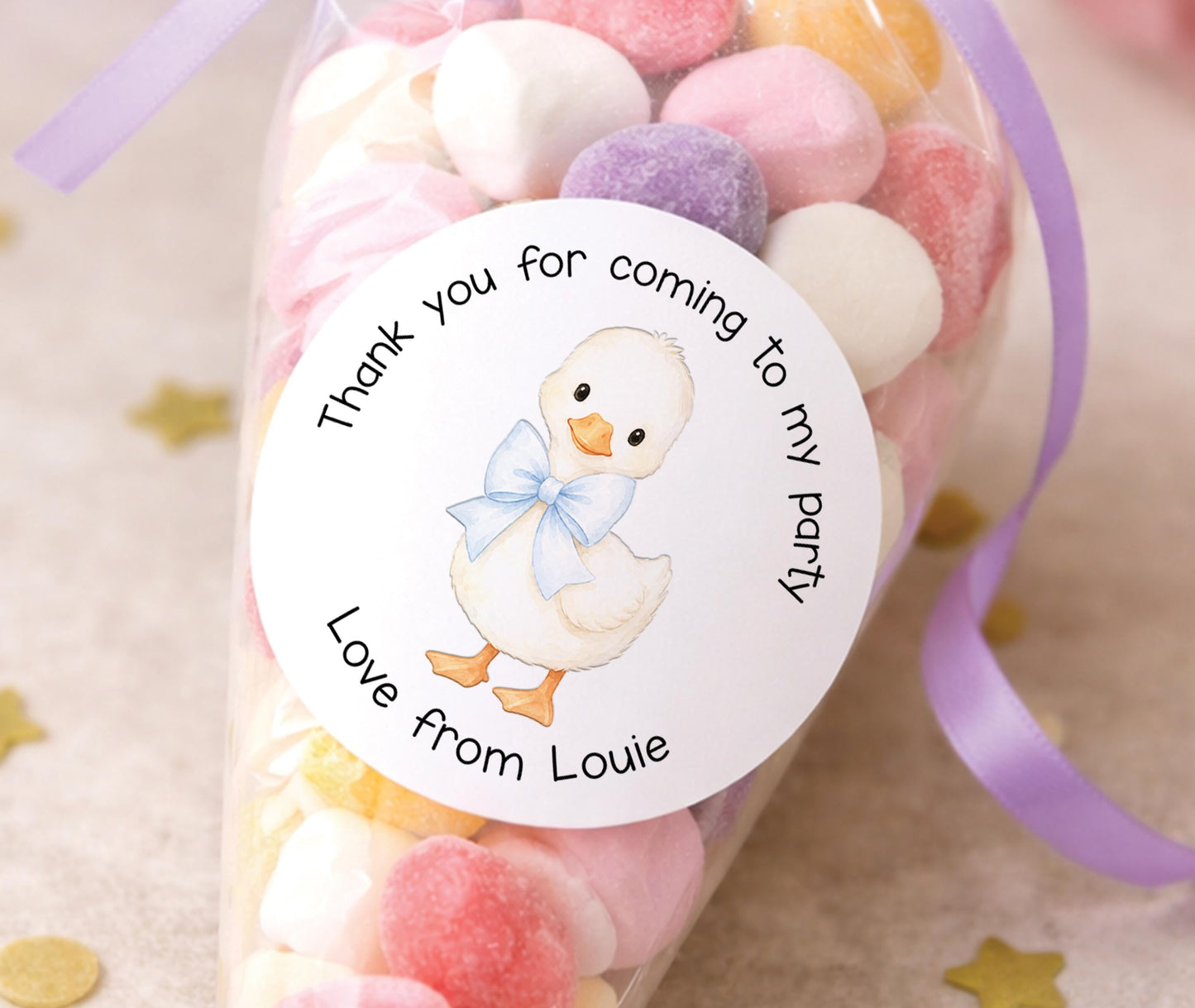 Personalised round duck stickers with a blue bow, printed with a child's name for party bags and favours.