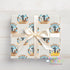 A gift box with a white ribbon tied around it, featuring a repeating pattern of a cowboy hat and a bull. The text "JAXON'S RODEO" is visible on the gift box.
