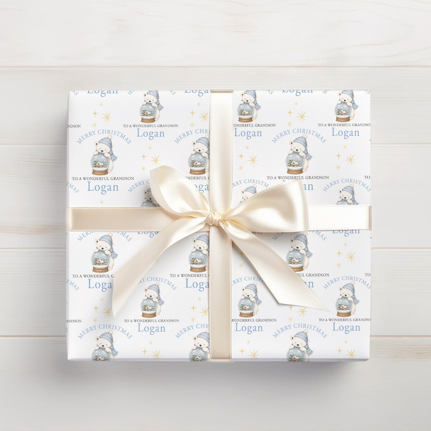 Personalised polar bear snow globe wrapping paper laid flat, showing the repeating custom name pattern.