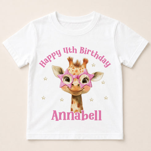 A white t-shirt with a giraffe wearing pink star-shaped glasses and the text "Happy 4th Birthday Annabel" printed on it.