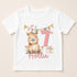 A white t-shirt with a cartoon image of a capybara wearing a party hat and the number 7, along with a gift box and a pink ribbon.