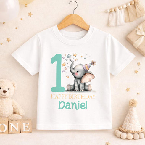 Personalised 1st birthday baby outfit with cute elephant, party hat, stars, teal number 1 and custom name, shown on bib, vest, sleepsuit, t-shirt and white pyjamas.
