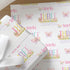 a repeating pattern of a white background with the name "Amelia" and the phrase "A magical birthday just for you!" written in pink and purple. The pattern is composed of multiple images of butterflies and flowers, creating a visually appealing and personalized design.