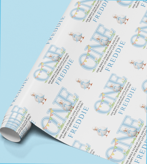 The image is a roll of wrapping paper with a repeating pattern of the name "FREDDIE" and a small illustration of a baby bird.