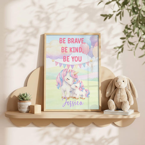 a framed poster with a unicorn and a bunny, along with a motivational message, placed on a shelf next to a stuffed animal.
