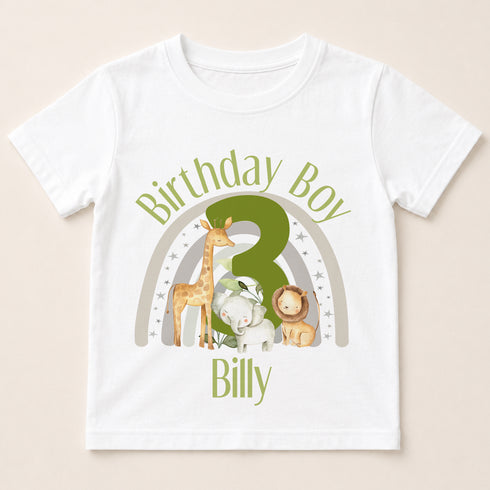 A white t-shirt with a graphic design featuring a giraffe, lion, and elephant, along with the text "Birthday Boy Billy" and a number 3.