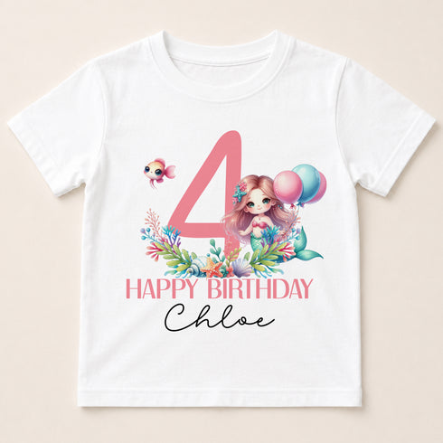 A white t-shirt with a birthday theme, featuring a mermaid character and balloons.