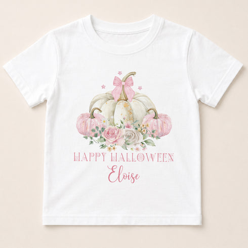 A white t-shirt with a graphic design featuring a floral arrangement of pumpkins and a bow, along with the text "Happy Halloween Eloise".