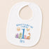 A white baby bib with a personalized design featuring a sun, a dragon, and a dinosaur, along with the text "When I wake up I will be Rex".