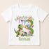 A white t-shirt with a graphic design featuring a green dinosaur and colorful balloons, along with the text "Birthday Boy Ronan" and the number "3".