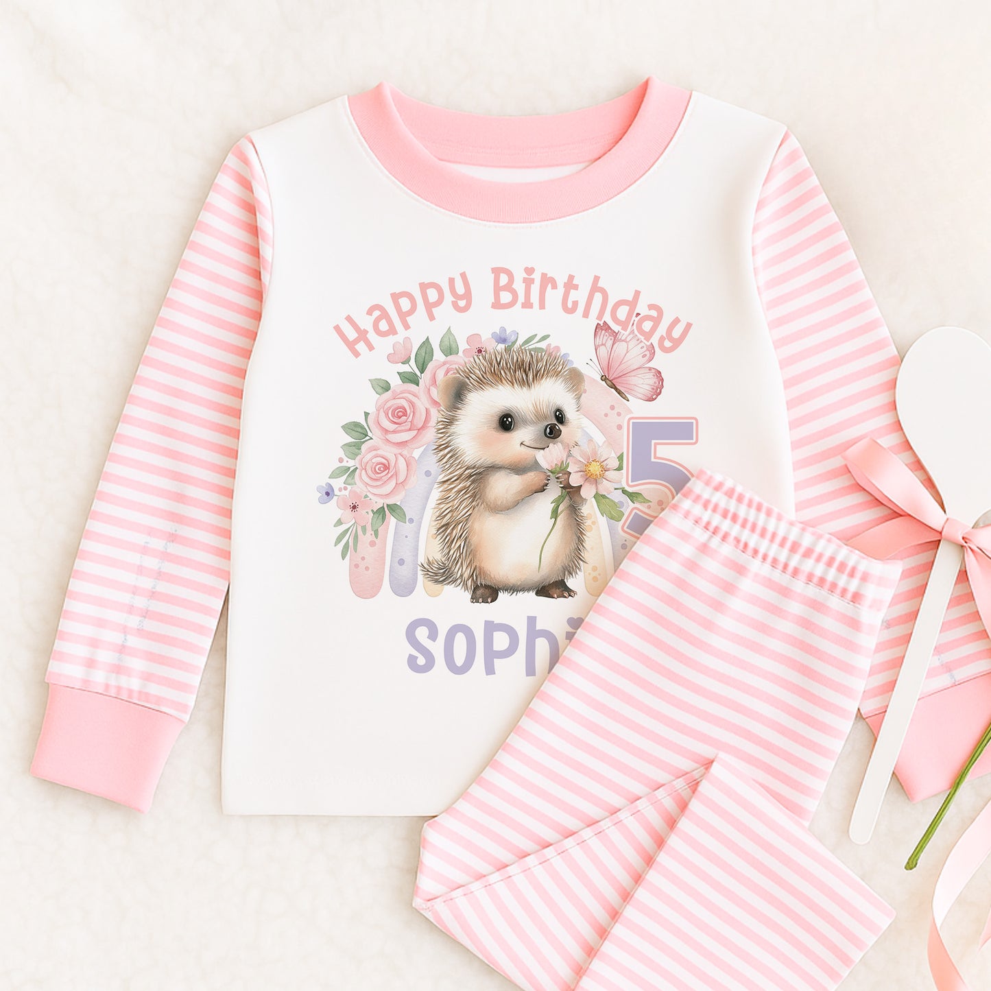 Personalised pink and white striped girls' pyjamas with rainbow hedgehog Happy Birthday design, size 6-12 months