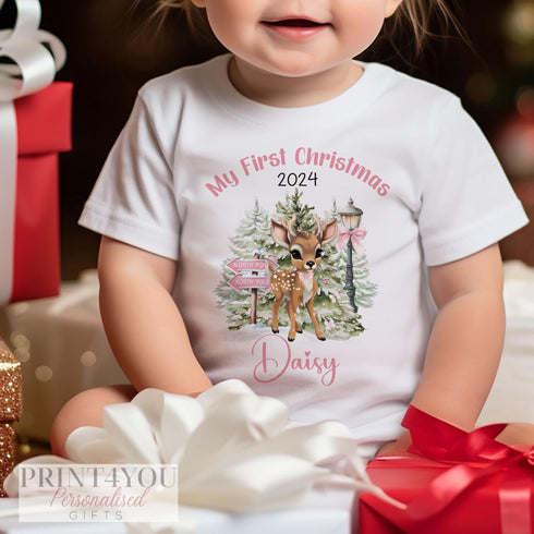 Babies first Xmas outfit, with a cute baby reindeer with pink accents printed onto white cotton vests, t-shirts, bibs, sleepsuits or buy as a set.