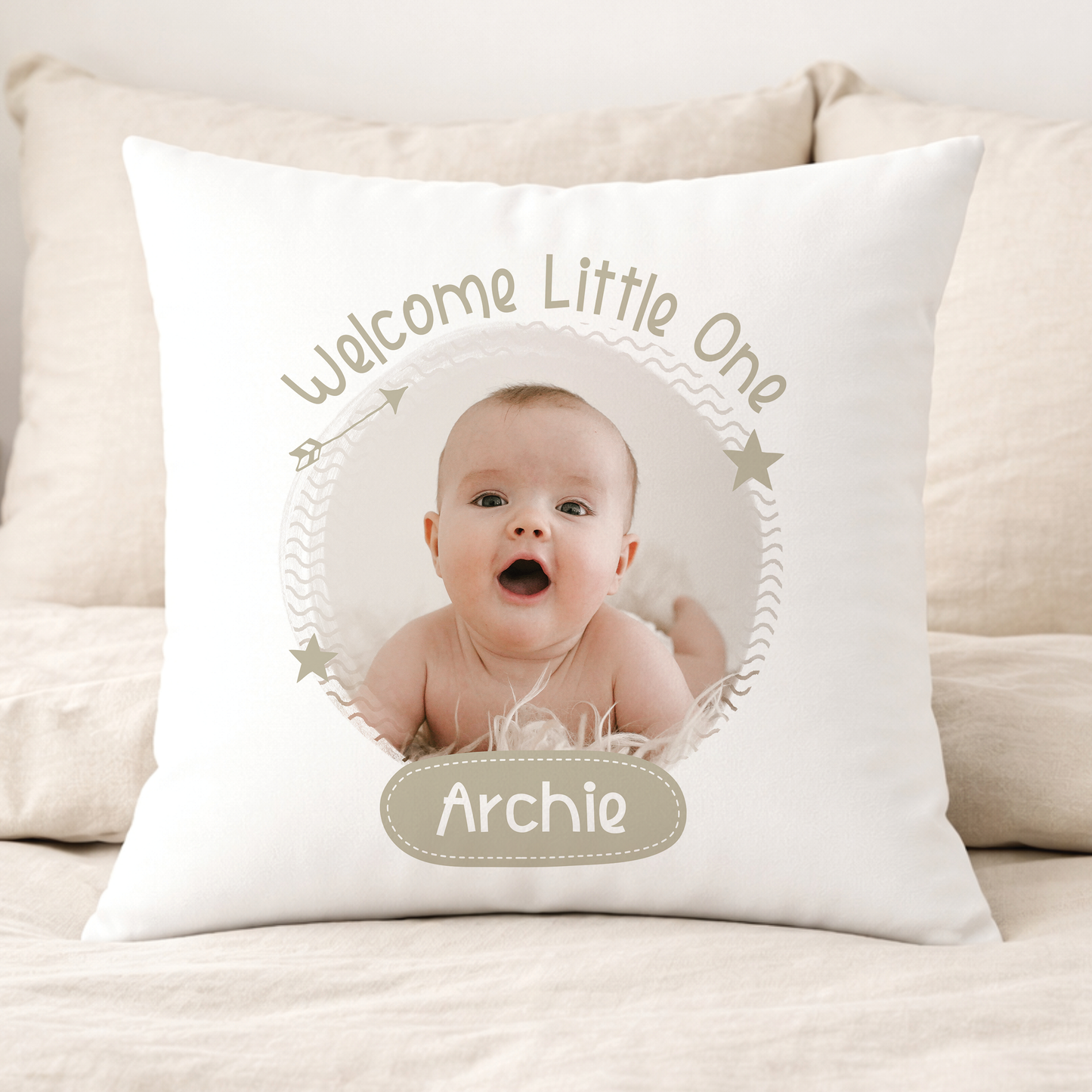 Beige personalised baby photo cushion with a 'welcome little one' design featuring a photo frame and space for baby's name, 40x40cm