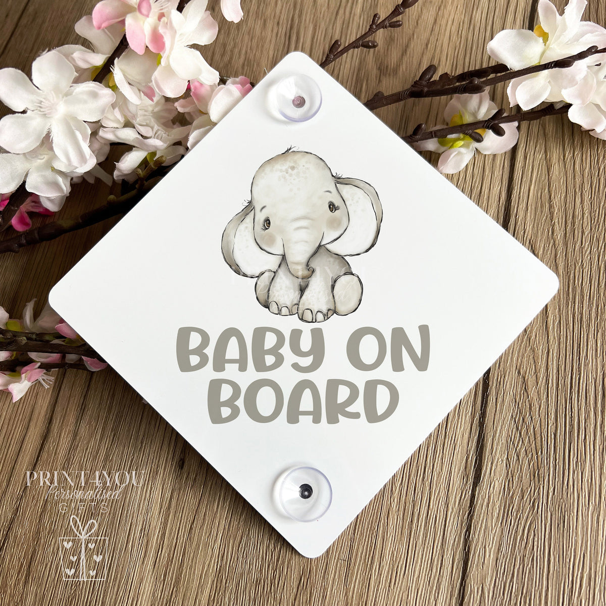 Baby on board car window sign with two suction cups attached to a car window, elephant safari design.