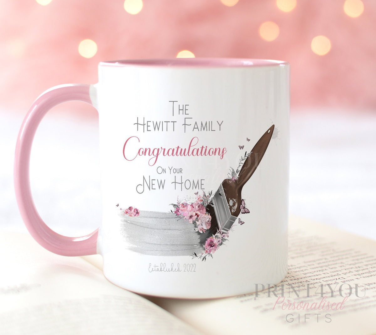 White ceramic mug with a paintbrush and flowers design and a pink trim handle