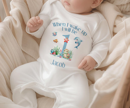 Blue and white striped first birthday garment with an under-the-sea print, personalised with a name.