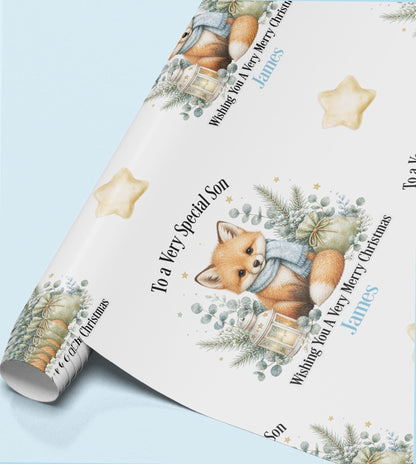 Rolled sheet of personalised fox Christmas wrapping paper printed with a name and relation