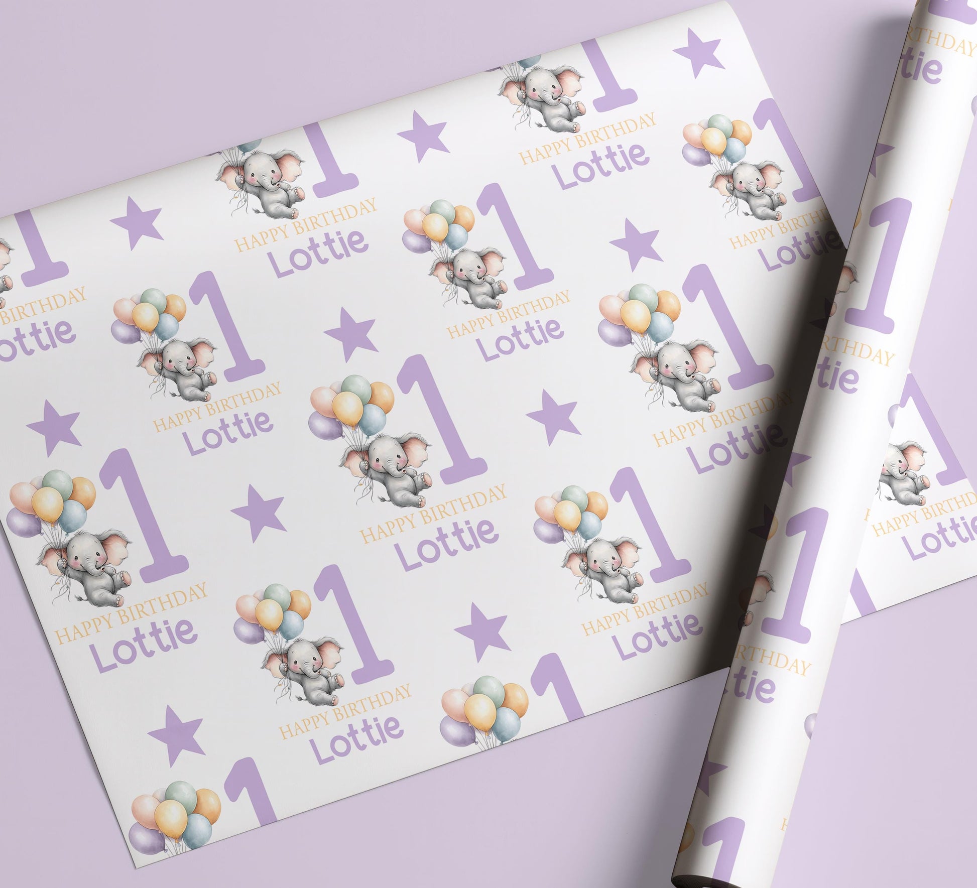 Sheet of personalised purple elephant 1st birthday wrapping paper laid flat