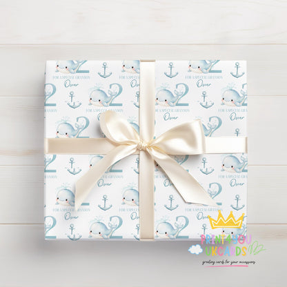 Personalised blue whale birthday wrap rolled and shown with a tape measure to indicate width.