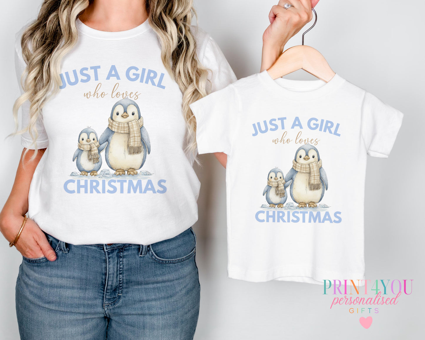 Mum and toddler wearing matching personalised Christmas t-shirts printed with a penguin pair design and 'Just a girl who loves Christmas'