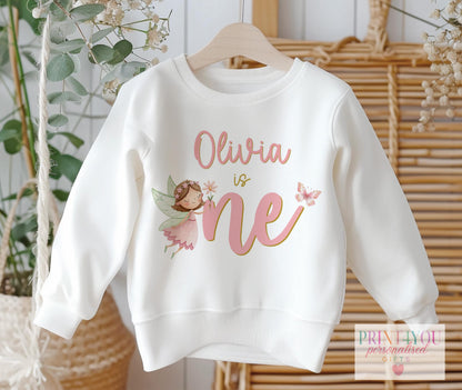 Baby girl 1st birthday sweatshirt with personalised fairy design and name, size 6-12 months, laid flat