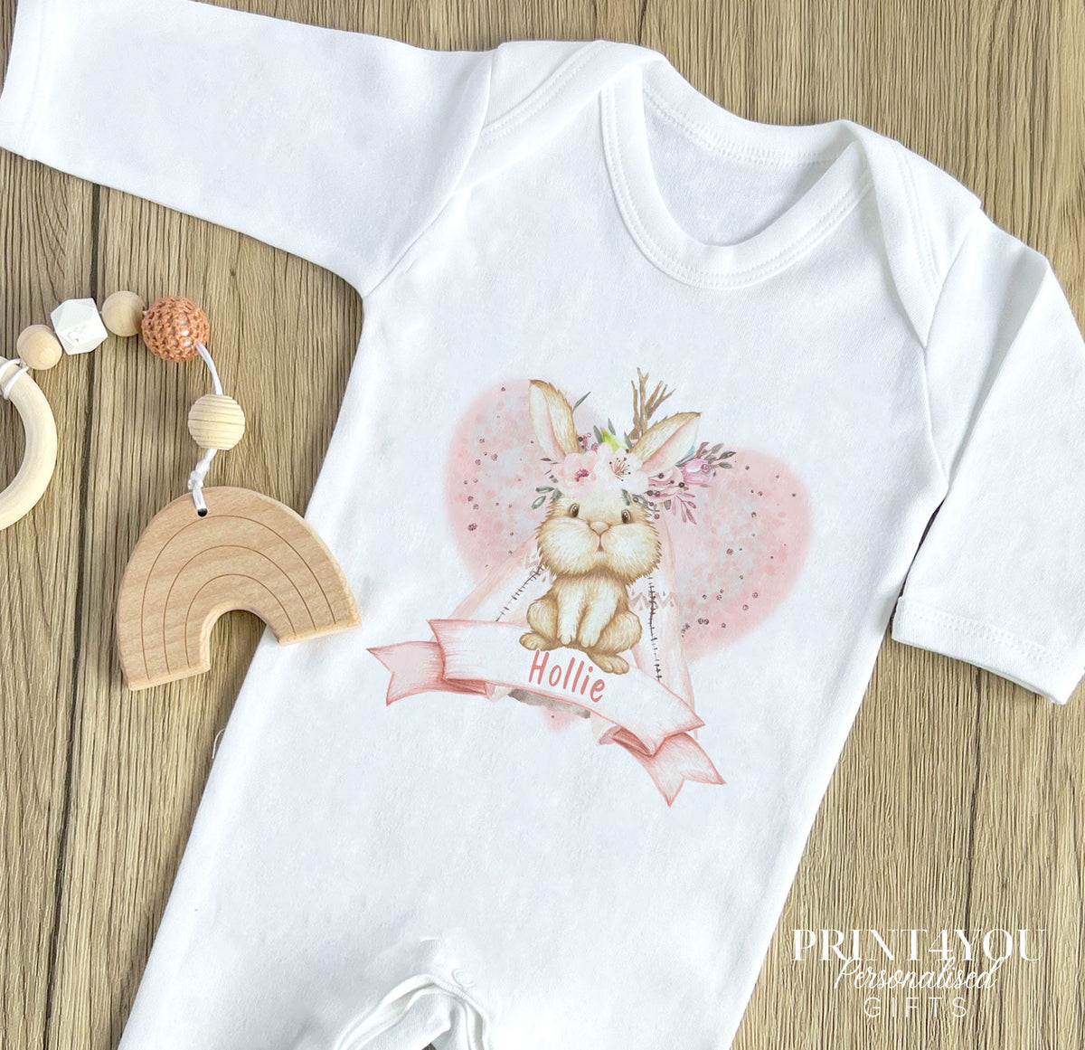 Personalised pink boho rabbit vest, printed with baby's name inside a heart design.