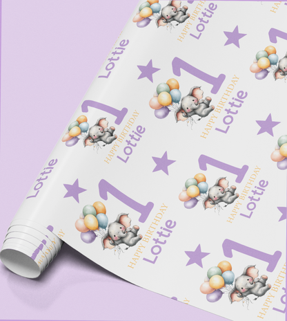 Roll of personalised purple elephant 1st birthday wrapping paper printed with a name