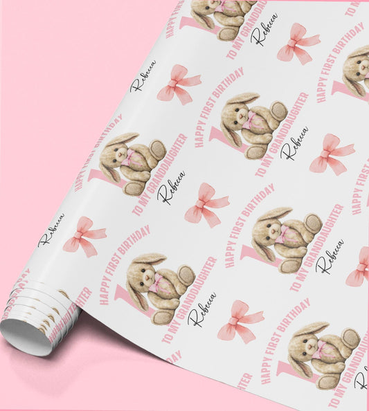 Roll of personalised pink rabbit wrapping paper with a bow design, printed with a custom name and relation