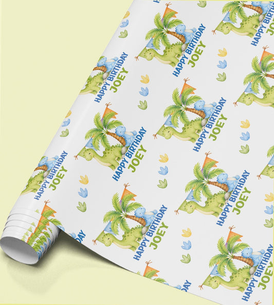 Personalised dinosaur birthday wrapping paper featuring cute blue and green dinosaurs, custom name, tropical trees and dinosaur footprints.