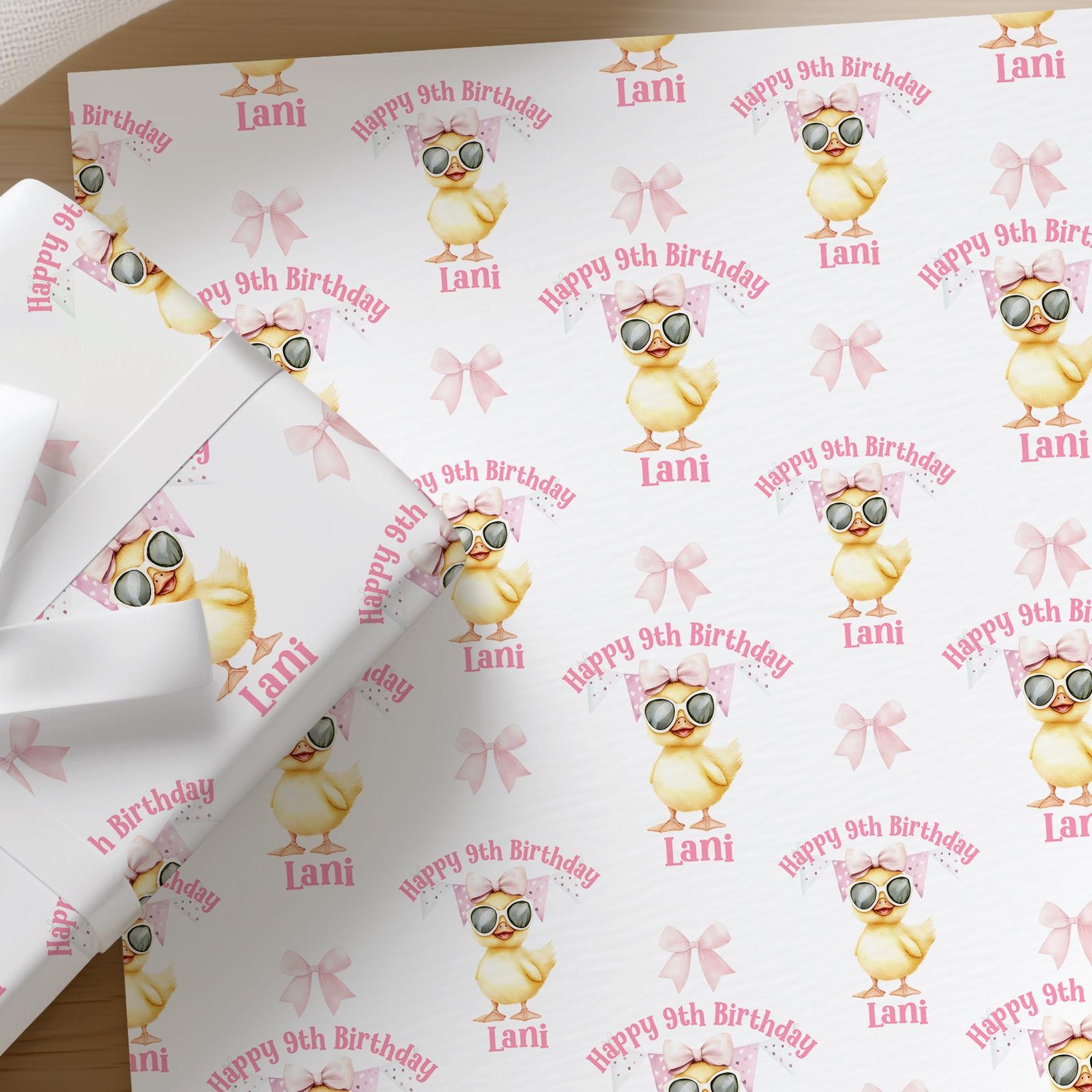 Roll of personalised duck birthday wrapping paper printed with a name and age
