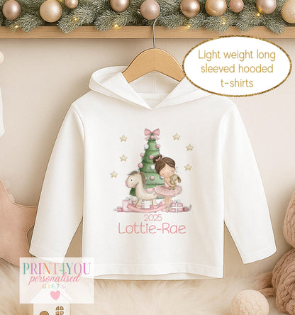 Personalised Christmas hooded t-shirt for girls, white long sleeved hoodie printed with a ballerina in a green tutu beside a Christmas tree and a name