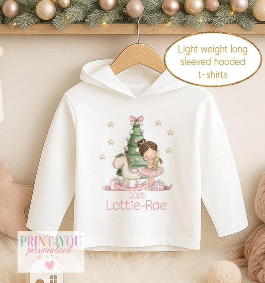 Personalised Christmas hooded t-shirt for girls, white long sleeved hoodie printed with a ballerina in a green tutu beside a Christmas tree and a name