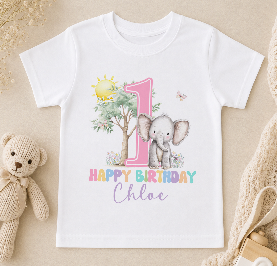 A white t-shirt with a pink number one and an elephant, along with the text "Happy Birthday Chloe" printed on it.