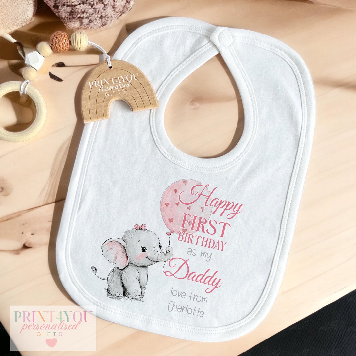 Baby wearing personalised pink elephant Daddy first birthday vest