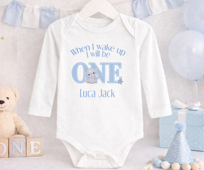 Personalised first birthday sleepsuit with blue elephant design and custom name print.