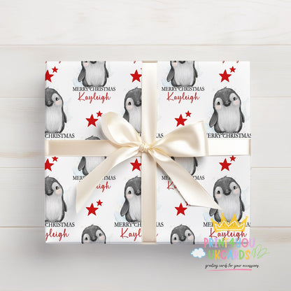 Roll of personalised penguin Christmas wrapping paper
